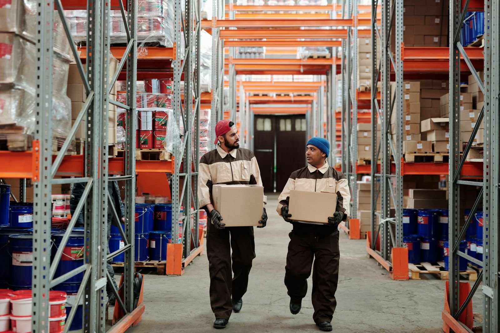 Logistics staff handling shipments in a warehouse, an operation where business automation answers status calls